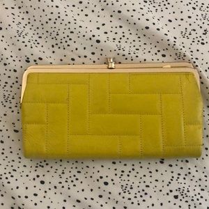 Patent Leather Lodis Clutch/wallet, yellow in color.